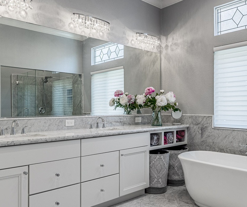 Remodeled master bathroom with marble counters and freestanding tub