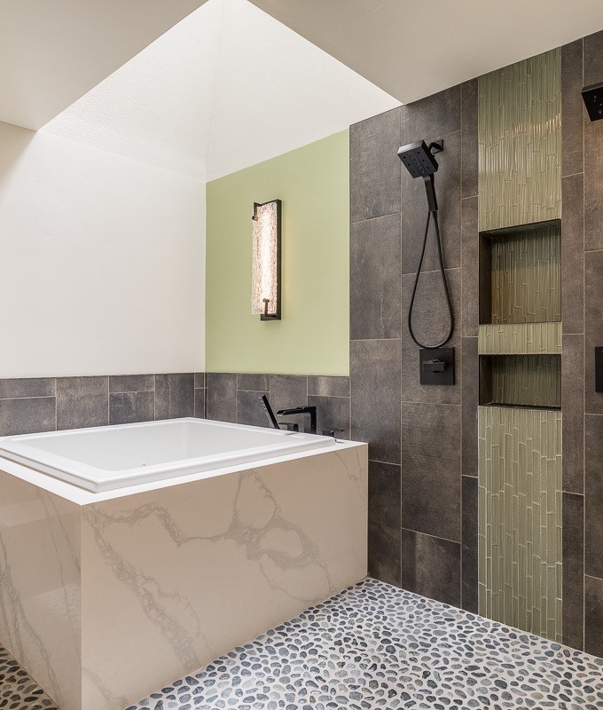 Yancey-designed powder room with backlit stone wall, vessel sink and pendant lighting