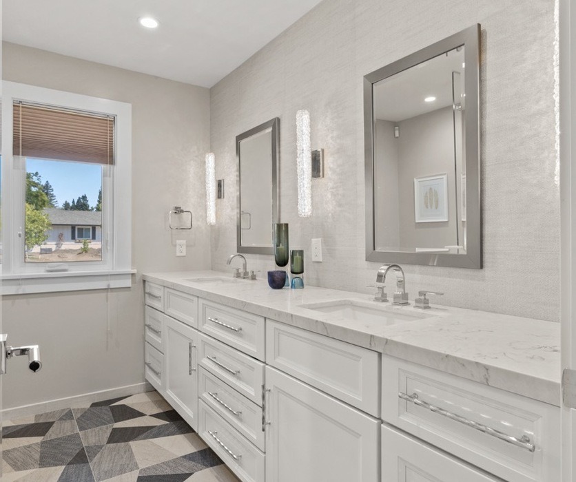 Remodeled master bathroom with double marble vanity